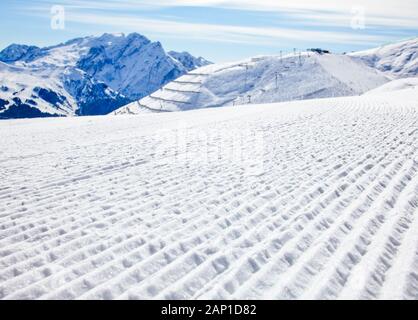 Freshly groomed piste on a ski slope at Val Di Fassa ski resort in Italy Stock Photo