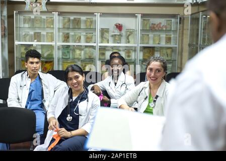 doctors, mixed race, in the classroom, at a medical conference. Young people, in white coats, with stethoscopes, are studying medicine. Classroom, ana Stock Photo