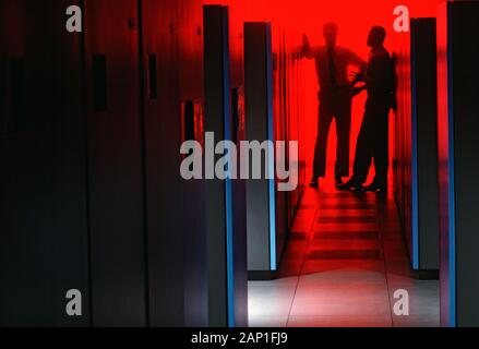 Two computer engineers meet at a cloud computing data center Stock Photo