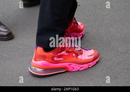 MILAN, ITALY - JANUARY 14, 2019: Man with red and pink Nike sneakers before Marco de Vincenzo fashion show, Milan Fashion Week street style Stock Photo