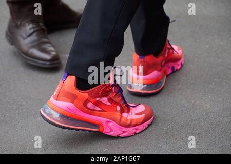 MILAN, ITALY - JANUARY 14, 2019: Man with red and pink Nike sneakers before Marco de Vincenzo fashion show, Milan Fashion Week street style Stock Photo