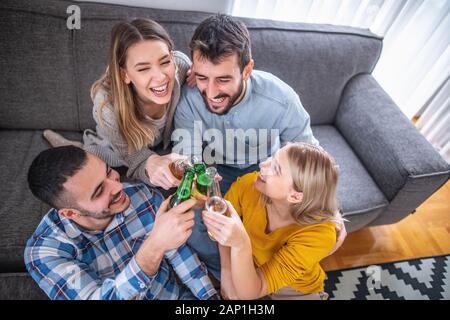 Group of friends enjoying soccer on TV.They are emotionally watching game in the living room. Stock Photo