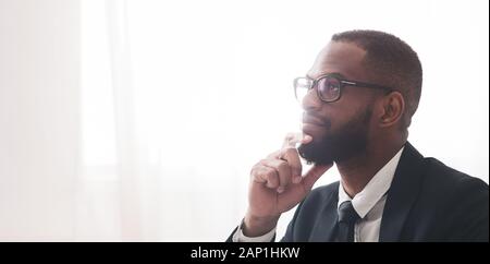 Close up of pensive black man in suit Stock Photo