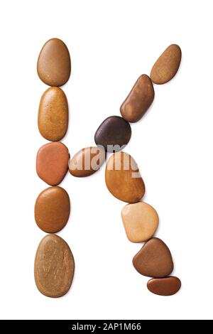 Letter K made of marine small pebbles, top view. Alphabet made of stones Isolated on a white background Stock Photo