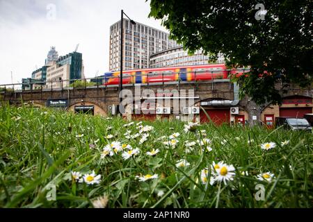 High rise buildings of the London district of Vauxhall overlook the railway's speeding trains and Vauxhall Pleasure Gardens park. Stock Photo