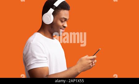 Side view of black man in wireless headphones Stock Photo