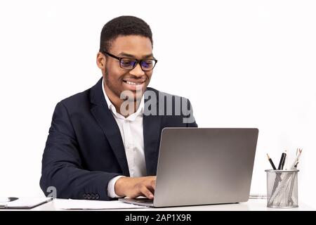 Concentrated african american man working with laptop Stock Photo