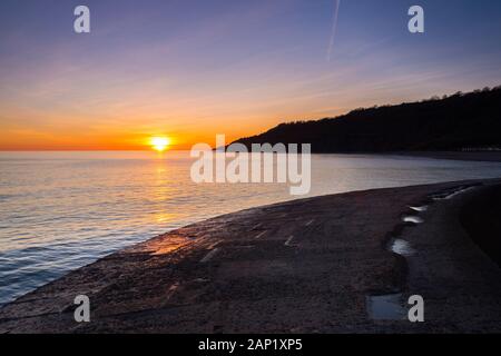 Lyme Regis, Dorset, UK.  20th January 2020. UK Weather.  Sunset viewed from the Cobb Harbour wall at Lyme Regis in Dorset at the end of a cold sunny day.  Picture Credit: Graham Hunt/Alamy Live News Stock Photo