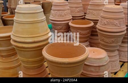 View on isolated stapled pile of brown terra cotta flower pots in german garden centre Stock Photo