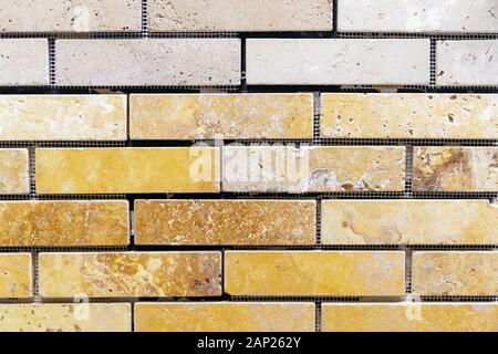 Wall of yellow and beige stone blocks. Background and texture of brickwork. Stock Photo