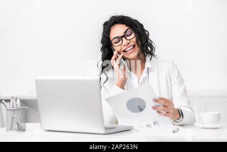 Portrait of latin businesswoman making phone call Stock Photo