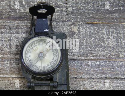 Close up of isolated old retro compass on wood table Stock Photo