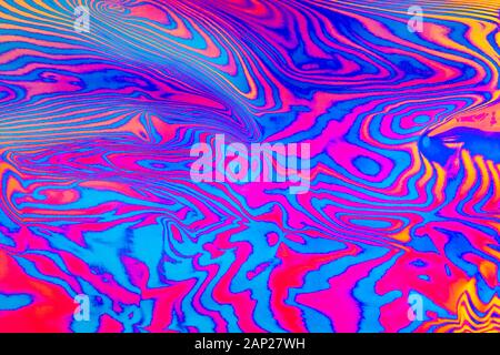 Abstract trendy neon colored psychedelic fluorescent striped zebra textured neon background Stock Photo