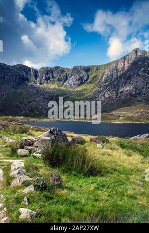 View of Llyn Idwal, a small lake within Cwm Idwal in the Glyderau mountains of Snowdonia, North Wales Stock Photo