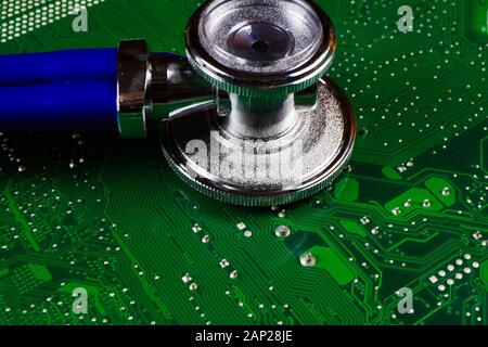 Digital health patient data storage concept - Isolated blue stethoscope on green computer circuit board Stock Photo