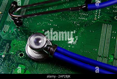 Digital health patient data storage concept - Isolated blue stethoscope on green computer circuit board Stock Photo