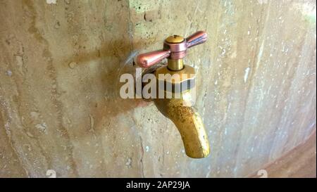 The tap in the wall is mineral water Stock Photo