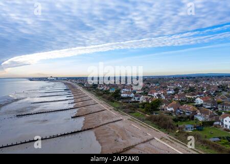 Aerial view of Felpham looking towards Bognor Regis and Butlins Holiday Village along the beach at low tide.