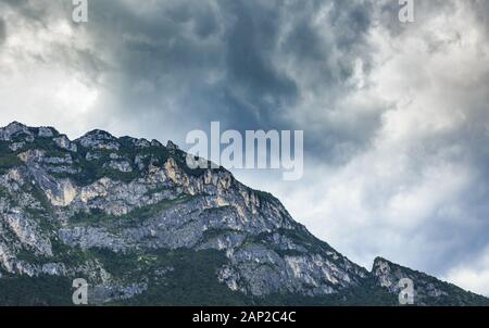 Dramatic sky above the mountain peaks at Riva del Garda near Garda lake, Italy. Stock Photo