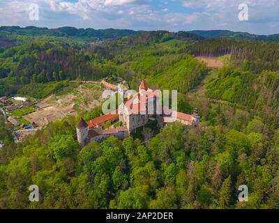 Aerial view of Moravian castle Pernstejn, standing on a hill above deep forests of the Bohemian-Moravian Highlands in Czech Republic Stock Photo