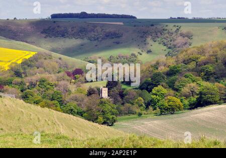 The Church of St James at Bratton, in a valley on the edge of Salisbury plain Wiltshire, sits among the many colours of the spring trees.UK Stock Photo