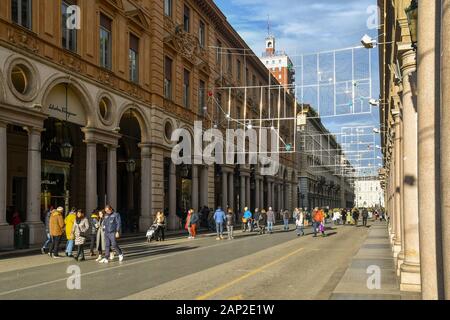 View of Via Roma street in the city centre of Turin with people and tourists walking during Christmas holidays in a sunny winter day, Piedmont, Italy Stock Photo