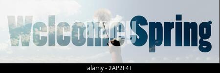 welcome spring inscription over dandelion in hand, panoramic image Stock Photo