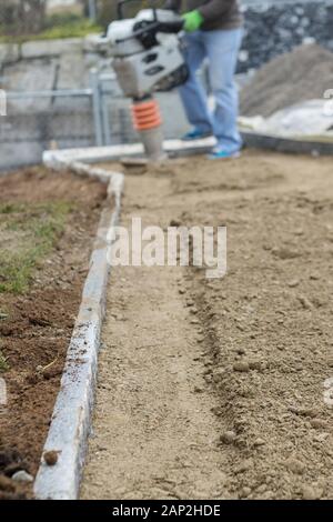 Stamping soil to build the garden path Stock Photo