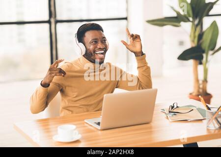 Young african businessman listening to music with headset Stock Photo