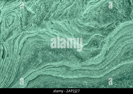 Stone textured background with roughness toned in neo mint color. Background for design or product. Stock Photo