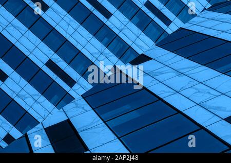 Classic blue concept. Glass or steel material background resembling hi-tech architecture or modern industrial building fragment. Diagonal geometric co Stock Photo