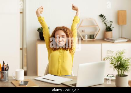 Break at work. Positive businesswoman relaxing at workplace Stock Photo