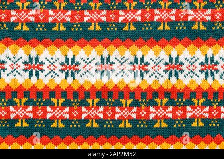 Motley christmas sweater texture with patterns. Colorful knit texture Stock Photo