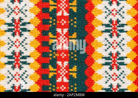 Motley christmas sweater texture with patterns. Colorful knit texture Stock Photo