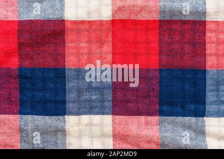 Plaid material texture. Red, blue and white cage clothes background Stock Photo