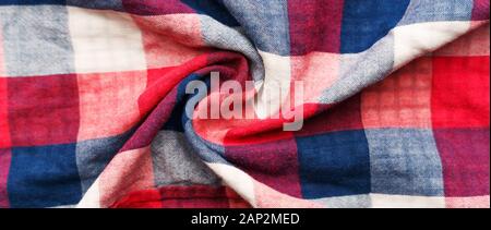 Plaid material texture. Red, blue and white cage clothes background Stock Photo