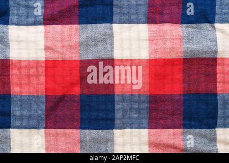 Plaid material texture. Red, blue and white cage clothes background Stock Photo