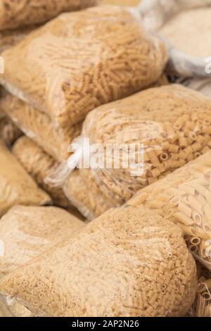 variety of pastas in transparent bags in a supermarket store Stock Photo