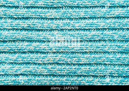 The texture of a blue turquoise knitted fabric. Sweater background Stock Photo