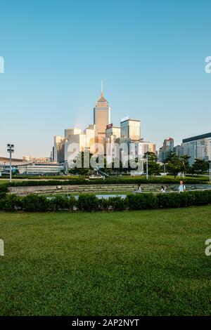 The Hong Kong Tamar Park near government headquarter building and Hongkong city skyline - Stock Photo