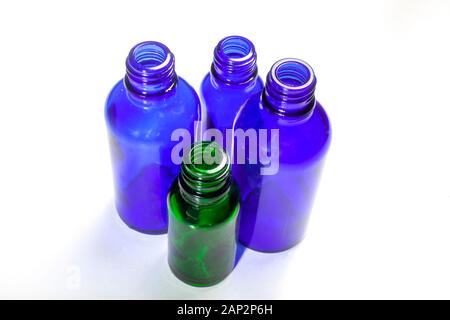 four bottles one green and three blue, photo shoot from the above on a white background Stock Photo