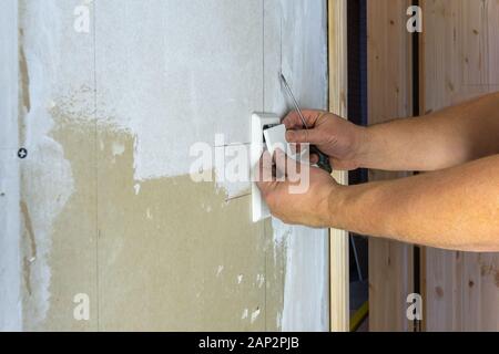 Craftsman Installing An Electricity Socket Stock Photo