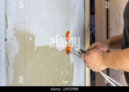 Craftsman Installing An Electricity Socket Stock Photo