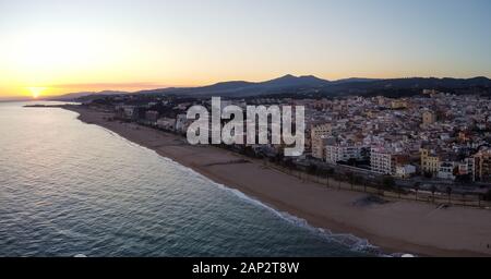 Aerial panoramic view of Canet de Mar city at dawn. Located in El ...