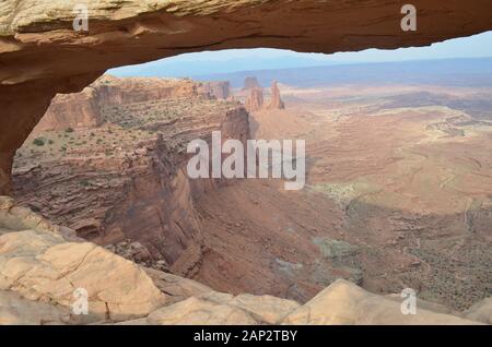 Summer in Canyonlands Island in the Sky: View Thru Mesa Arch of Buck Canyon, White Rim, Monster Tower, Washer Woman Arch, Airport Tower & La Sal Mtns Stock Photo