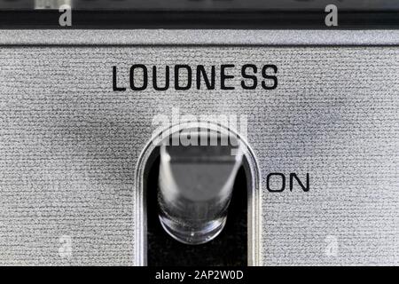 Close up macro photograph of loudness toggle switch detail on vintage boombox stereo. Stock Photo