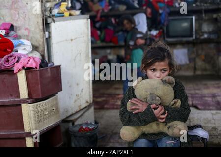 Gaza City, The Gaza Strip, Palestine. 19th Jan, 2020. A Palestinian girl holds a teddy bear in their house in the Al-Zuhur neighborhood, on the outskirts of Khan Yunis refugee camp, in the southern Gaza Strip. The expansion of the Al-Zuhur neighborhood, where barefoot children play in the rusty skeletons of abandoned vehicles surrounded by mountains of garbage, is a sign of the times in Gaza, where poverty grows and there is little hope for the future. Credit: Mahmoud Issa/Quds Net News/ZUMA Wire/Alamy Live News Stock Photo