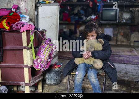 Gaza City, The Gaza Strip, Palestine. 19th Jan, 2020. A Palestinian girl holds a teddy bear in their house in the Al-Zuhur neighborhood, on the outskirts of Khan Yunis refugee camp, in the southern Gaza Strip. The expansion of the Al-Zuhur neighborhood, where barefoot children play in the rusty skeletons of abandoned vehicles surrounded by mountains of garbage, is a sign of the times in Gaza, where poverty grows and there is little hope for the future. Credit: Mahmoud Issa/Quds Net News/ZUMA Wire/Alamy Live News Stock Photo