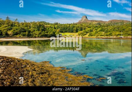 Isle of Eigg, Small Isles, Hebrides, Scotland.  A beautiful bay at low tide with silver sands and An Sgurr in the background, reflected in the water. Stock Photo