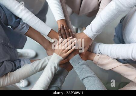 Business team putting hands together on top of each other Stock Photo